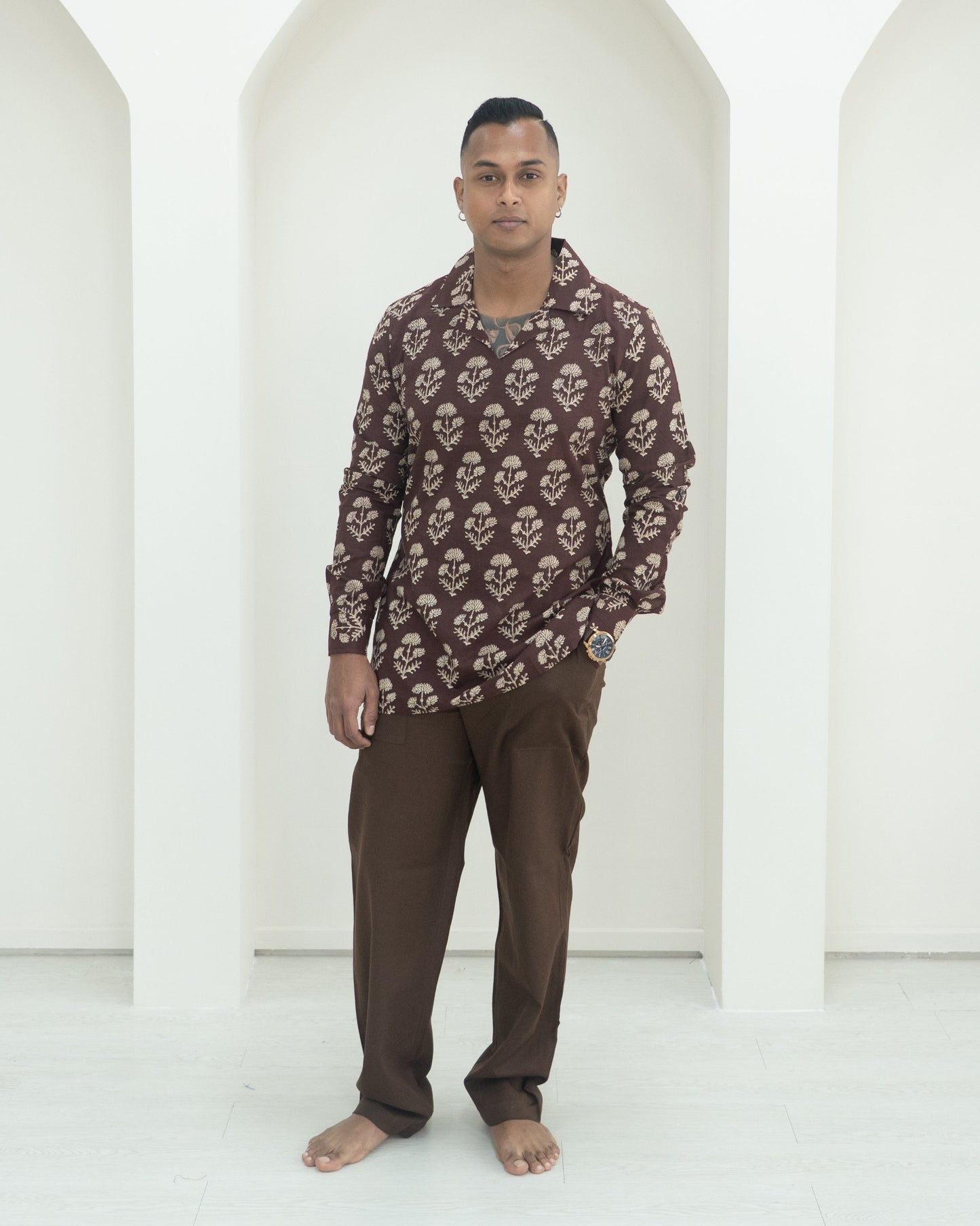 Man wearing a patterned shirt and pants.