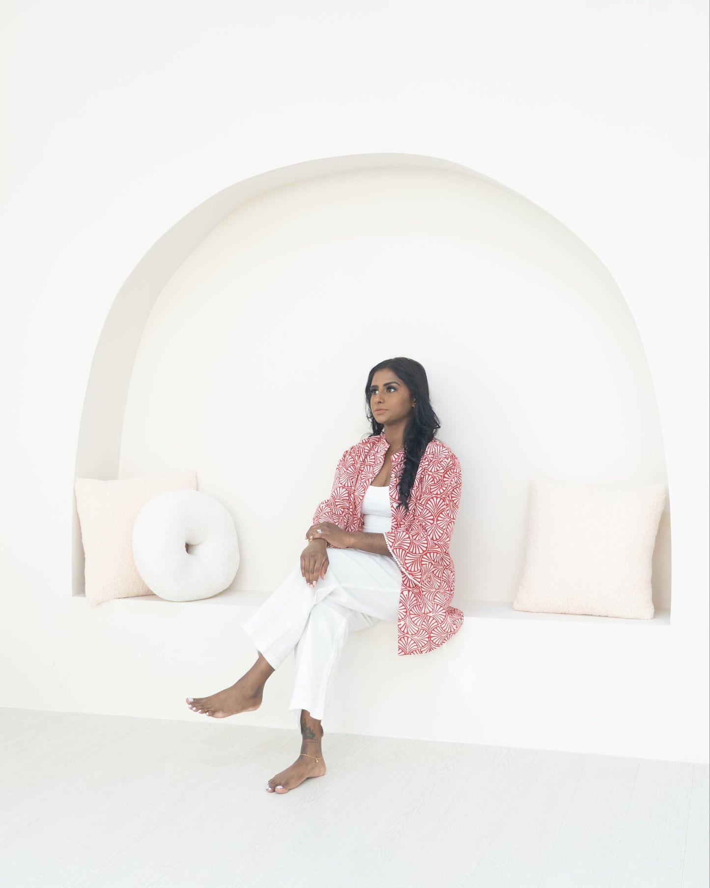 Woman sitting on a bench with a white background