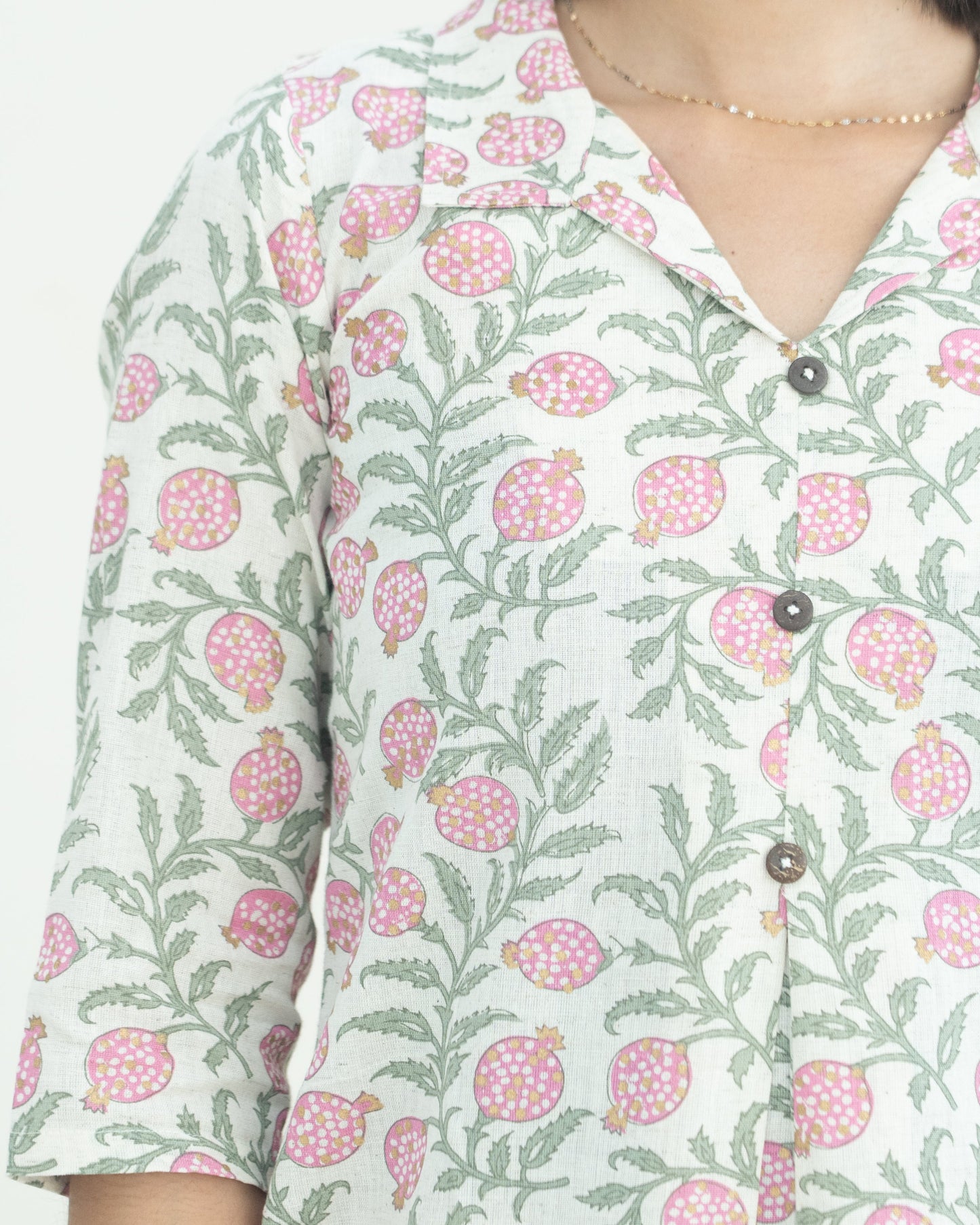 Floral patterned dress worn by a lady on a light background