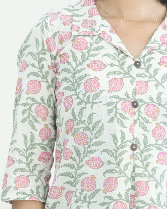 Floral patterned dress worn by a lady on a light background