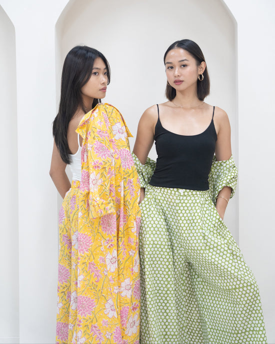 Two women standing side by side against a white background.