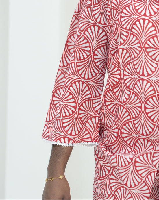 Red and white patterned outfit with a plain background