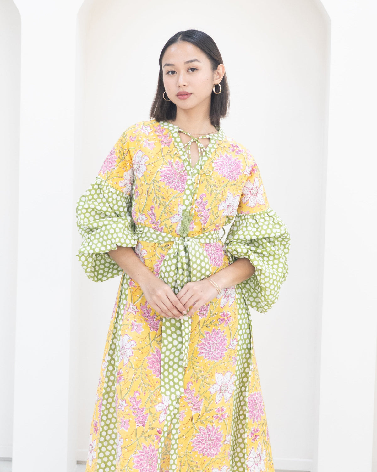 Woman wearing a floral dress with a white background