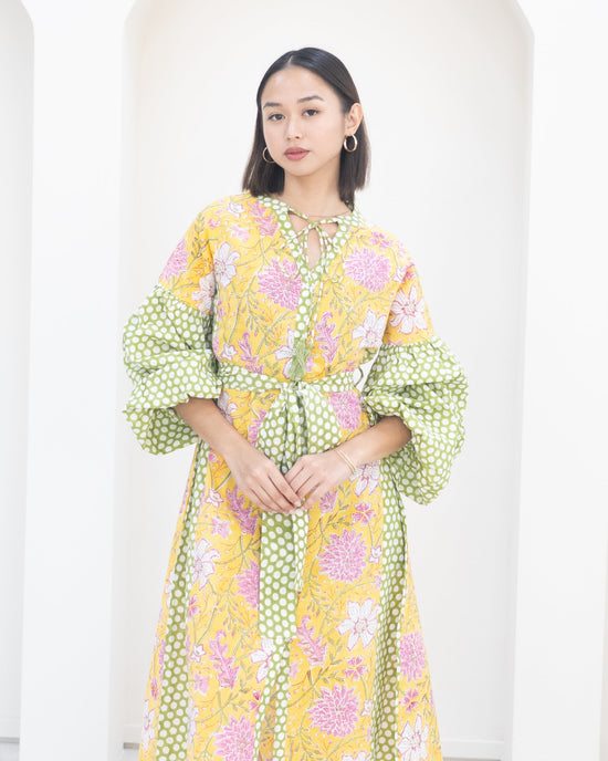 Woman wearing a floral dress with a white background