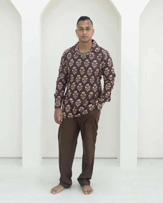 Man wearing a patterned shirt and pants.